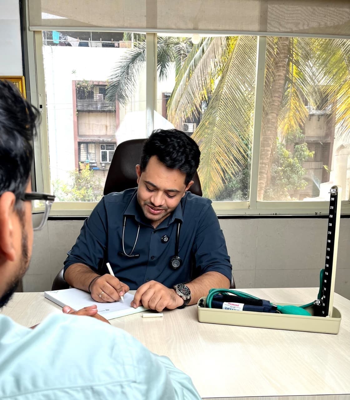 Dr. Aditya Davhale consulting a patient